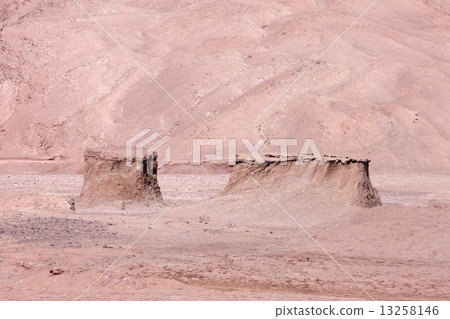Aesthetic beauty of the rocks of the Moon Valley in the Atacama Desert spreading at the foot of the mountain of the soft sunny, lit South American Andes in the afternoon 13258146