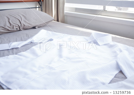 Shirt spread on the bed 13259736