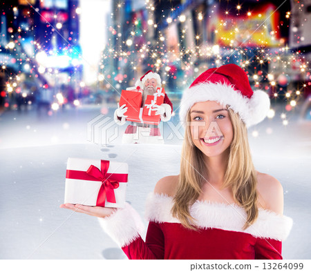 Composite image of pretty santa girl holding gift Composite image of pretty santa girl holding gift 13264099