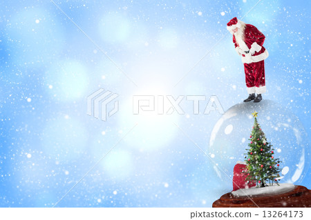 Composite image of santa standing on snow globe Composite image of santa standing on snow globe 13264173