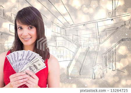 Composite image of brunette showing fan of dollars 13264725