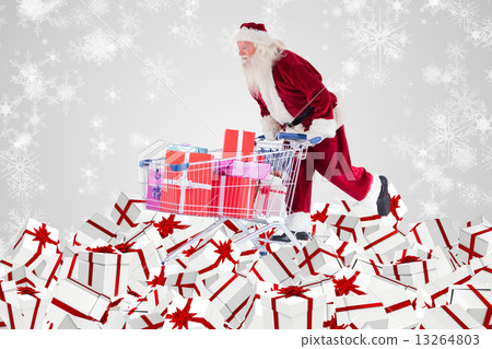 Composite image of santa delivering gifts from cart Composite image of santa delivering gifts from cart 13264803