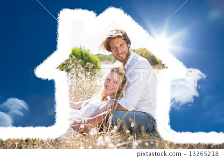 Composite image of attractive couple relaxing in the countryside 13265218