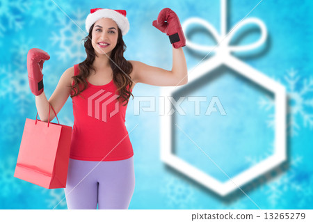 Composite image of festive brunette in boxing gloves with shoppi Composite image of festive brunette in boxing gloves with shoppi 13265279