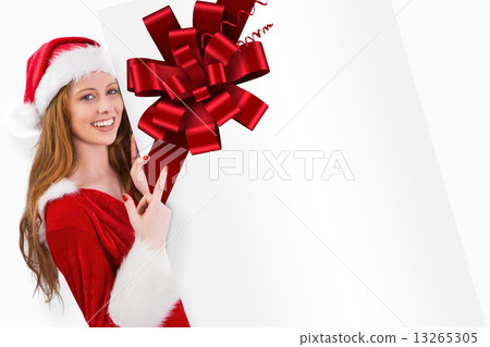 Composite image of festive redhead smiling at camera holding pos 13265305