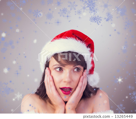 Composite image of pretty santa girl with hands on face Composite image of pretty santa girl with hands on face 13265449