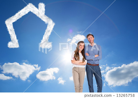 Composite image of smiling young couple with arms crossed 13265758