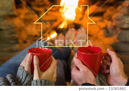 Composite image of hands with red coffee cups in front of lit fi Composite image of hands with red coffee cups in front of lit fi 13265862