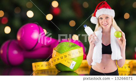Composite image of festive fit blonde smiling at camera 13266071