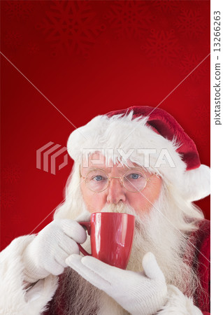 Composite image of santa drinks from a red cup 13266263