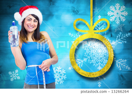 Festive fit brunette measuring her waist 13266264