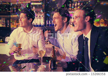 Composite image of handsome friends having a drink together 13266358