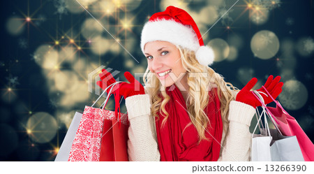 Composite image of happy festive blonde with shopping bags 13266390