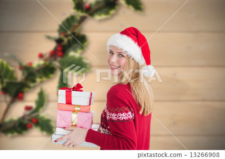 Composite image of woman holding christmas presents Composite image of woman holding christmas presents 13266908