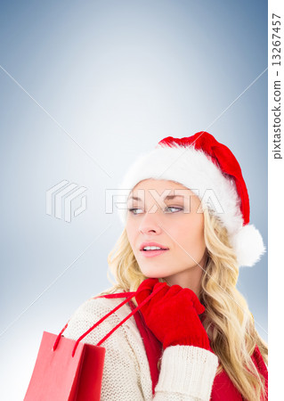Composite image of happy festive blonde with shopping bag 13267457