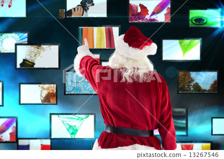 Composite image of santa claus points at something 13267546