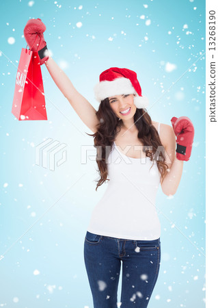 Composite image of festive brunette in boxing gloves with shoppi Composite image of festive brunette in boxing gloves with shoppi 13268190