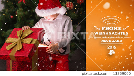 Composite image of child opening his christmas present Composite image of child opening his christmas present 13269060