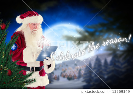 Composite image of santa uses a tablet pc 13269349