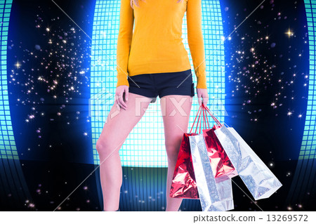 Composite image of stylish woman with shopping bags Composite image of stylish woman with shopping bags 13269572