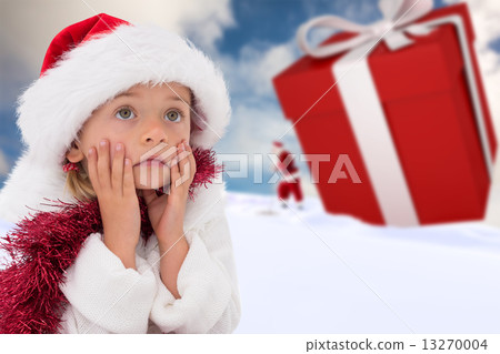 Composite image of cute little girl wearing santa hat and tinsel 13270004