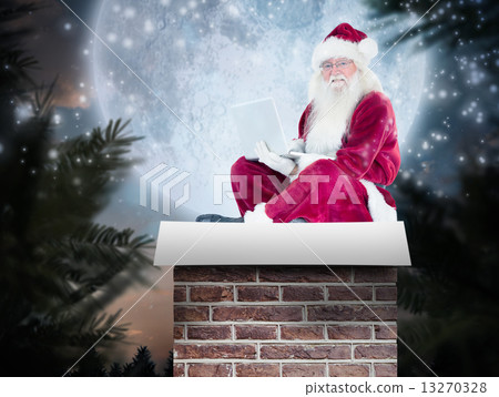 Composite image of santa sits and uses a laptop Composite image of santa sits and uses a laptop 13270328