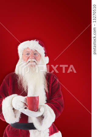 Composite image of santa holds a red cup 13270510
