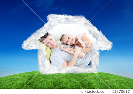 Composite image of caress young couple lying together on the sof 13270617