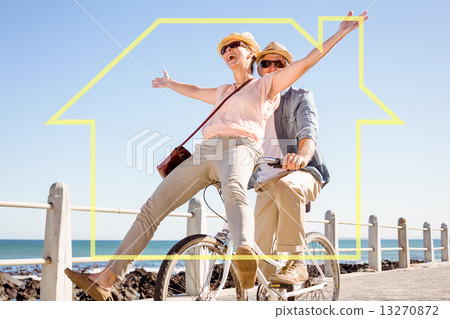 Composite image of happy casual couple going for a bike ride on Composite image of happy casual couple going for a bike ride on 13270872