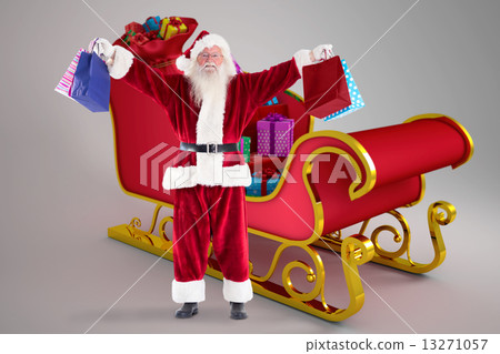 Composite image of santa holds some bags for chistmas 13271057