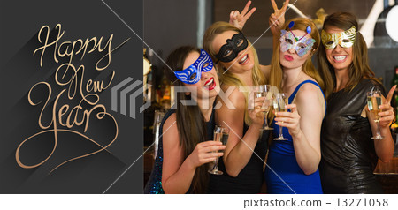 Composite image of attractive women wearing masks holding champa Composite image of attractive women wearing masks holding champa 13271058