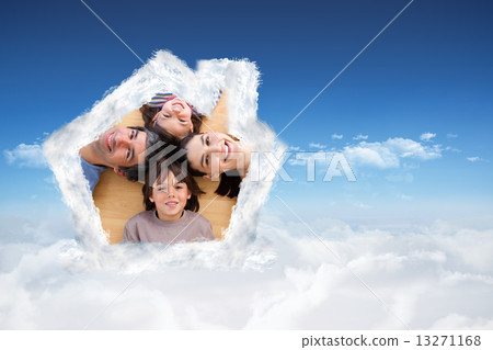Composite image of smiling young family lying on the floor with 13271168