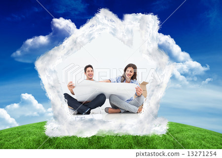 Composite image of man and his wife looking at their house plans 13271254