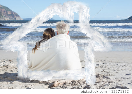 Composite image of couple sitting on the beach under blanket loo Composite image of couple sitting on the beach under blanket loo 13271552