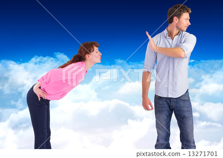 Composite image of man stopping woman from kissing 13271701