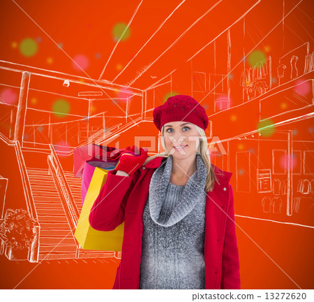 Composite image of blonde in winter clothes holding shopping bag 13272620