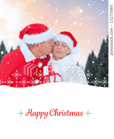 Composite image of festive mature couple holding gift 13273065