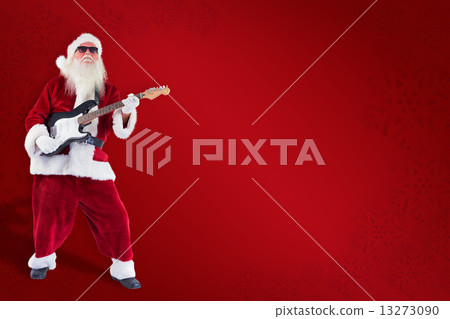 Composite image of santa claus plays guitar with sunglasses 13273090