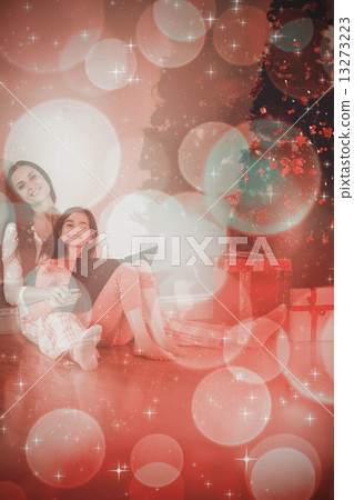 Composite image of mother and daughter waiting for santa claus Composite image of mother and daughter waiting for santa claus 13273223