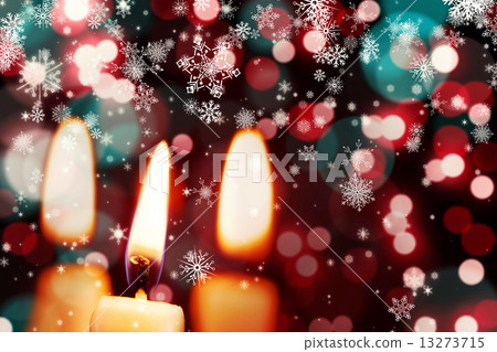 Snowflakes against candle burning Snowflakes against candle burning 13273715