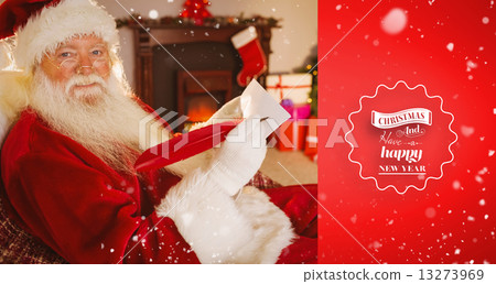 Composite image of smiling santa writing list with a quill 13273969