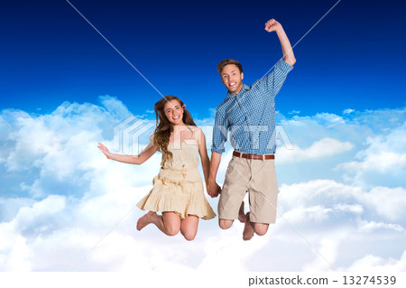 Composite image of cheerful young couple jumping 13274539