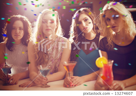 Composite image of attractive friends drinking cocktails togethe Composite image of attractive friends drinking cocktails togethe 13274607