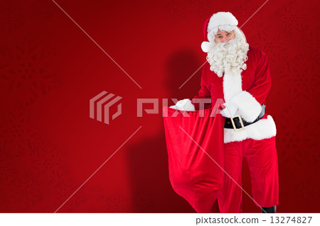 Composite image of smiling santa claus opening sack 13274827