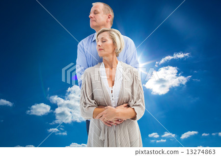 Composite image of happy mature couple embracing with eyes close Composite image of happy mature couple embracing with eyes close 13274863