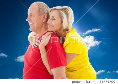 Composite image of happy mature couple hugging and smiling 13275209