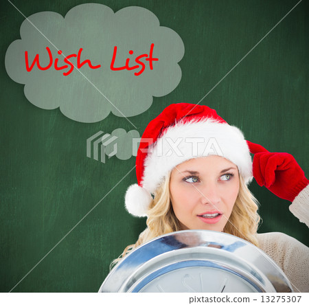 Composite image of happy festive blonde with clock 13275307