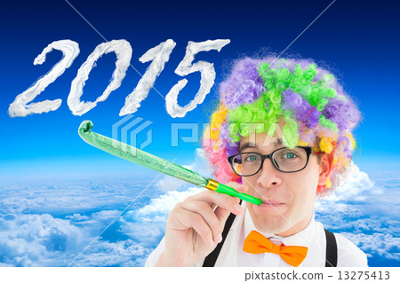 Composite image of geek blowing party horn 13275413