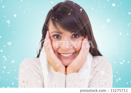 Composite image of brunette in winter clothes smiling at camera 13275711
