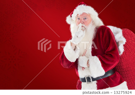 Composite image of santa asking for quiet with bag 13275924